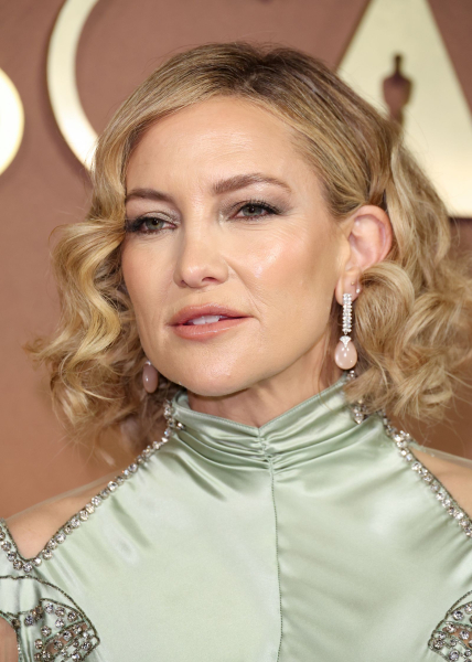 Kate Hudson in a green high neck dress and diamond drop earrings